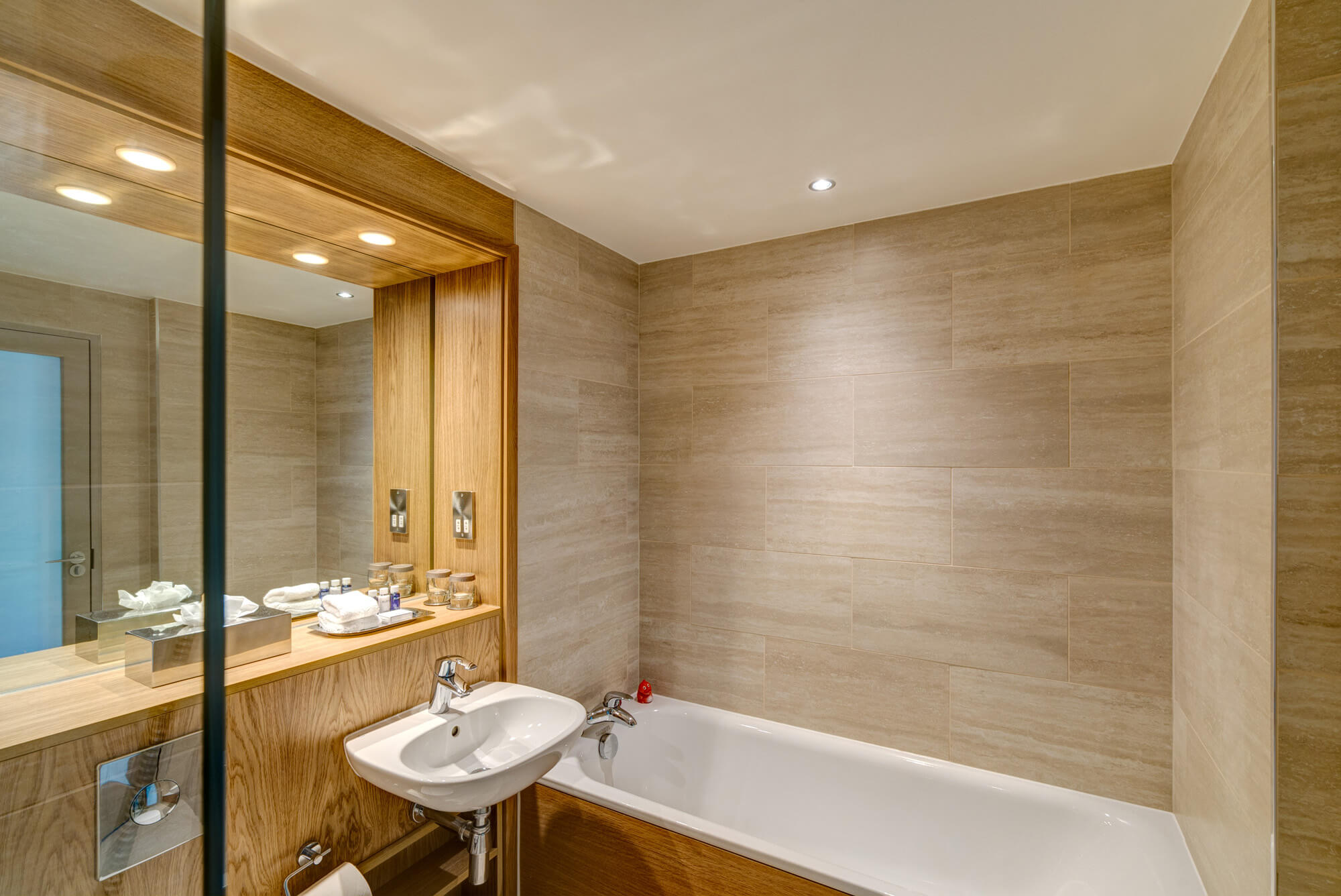 Bath tub next to sink in bathroom